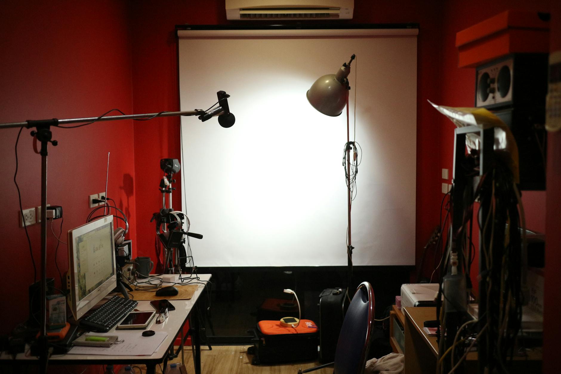 A professional podcast studio with recording equipment, lights, and computer setup in Bangkok.