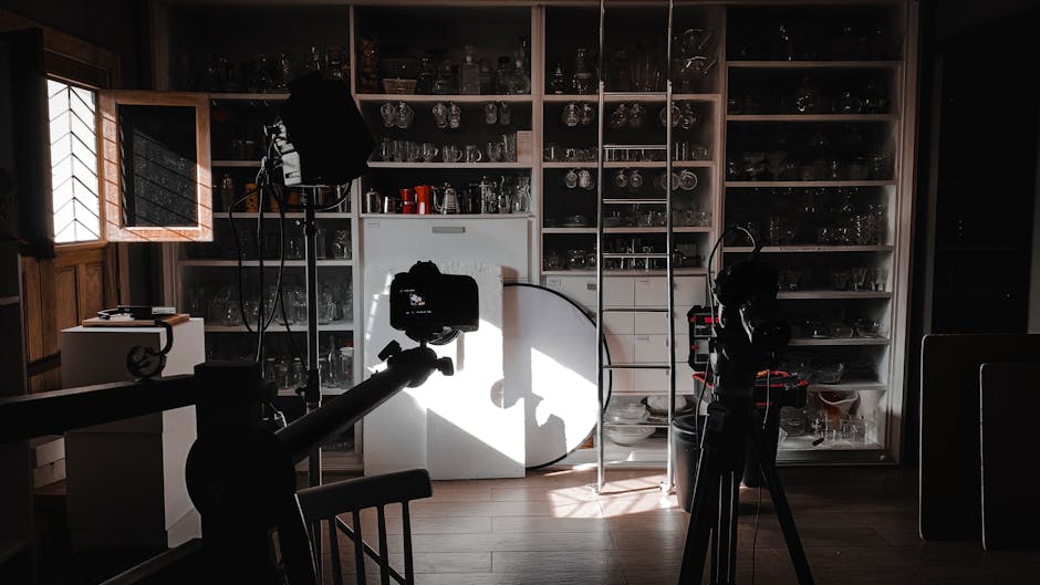 Interior view of a photography studio with cameras, lights, and equipment setup for a shoot.
